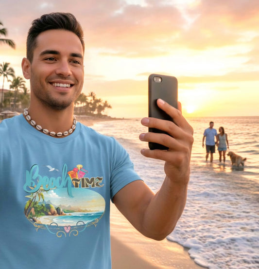 Man taking a selfie on a beach with 'Beach Time' t-shirt, sunset in the background