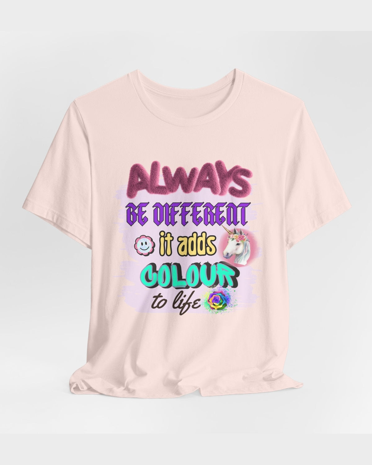 Pink t-shirt with colorful Motovational text and graphics on a light gray background