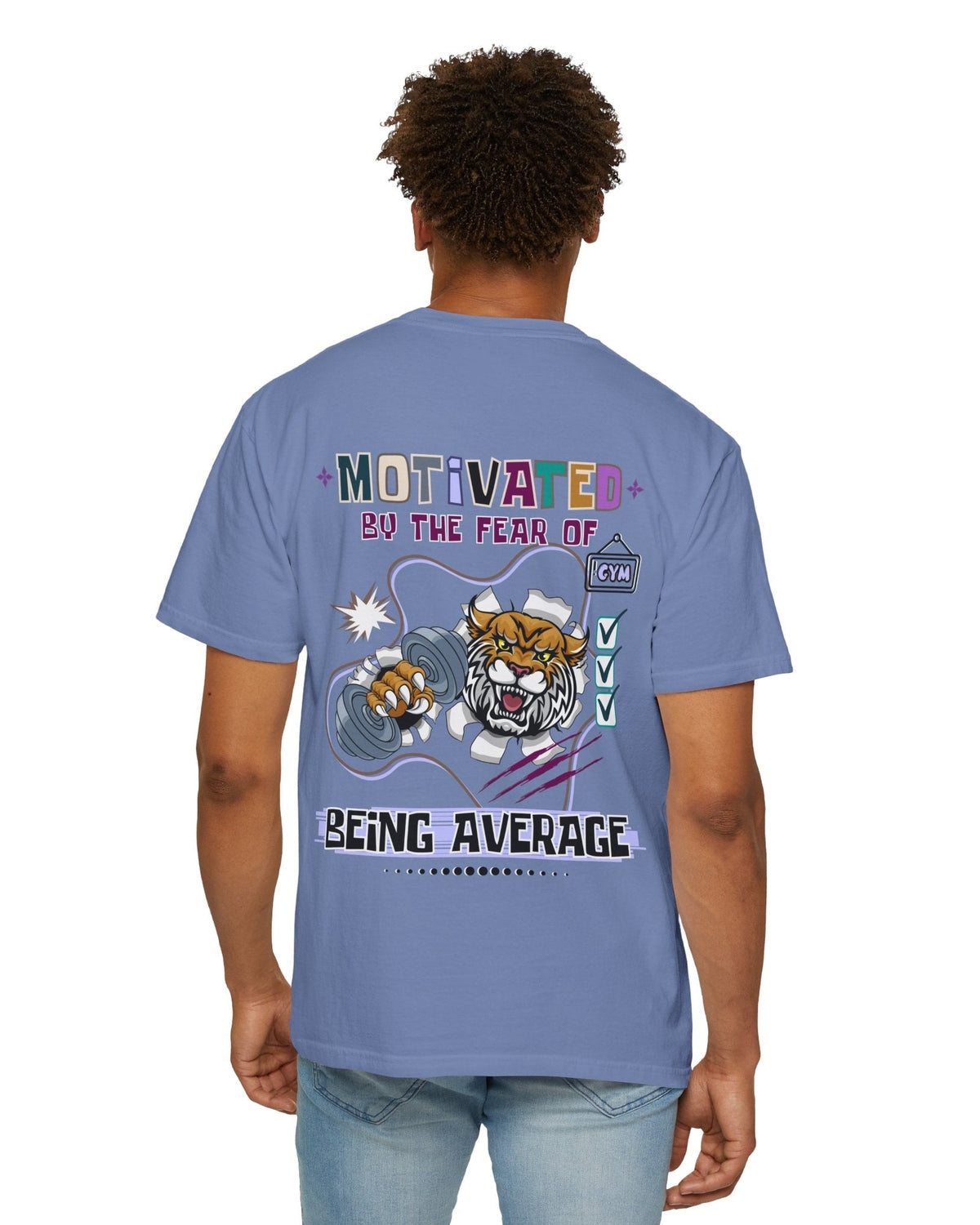 Person wearing a blue t-shirt with motivational text Motivated by the fear of being average and tiger graphics on the back.