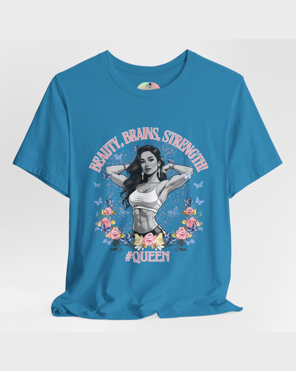 Blue t-shirt with a graphic design of a fitness woman, flowers, butterflies and text 'Beauty, Brains, Strength #Queen' on a white background