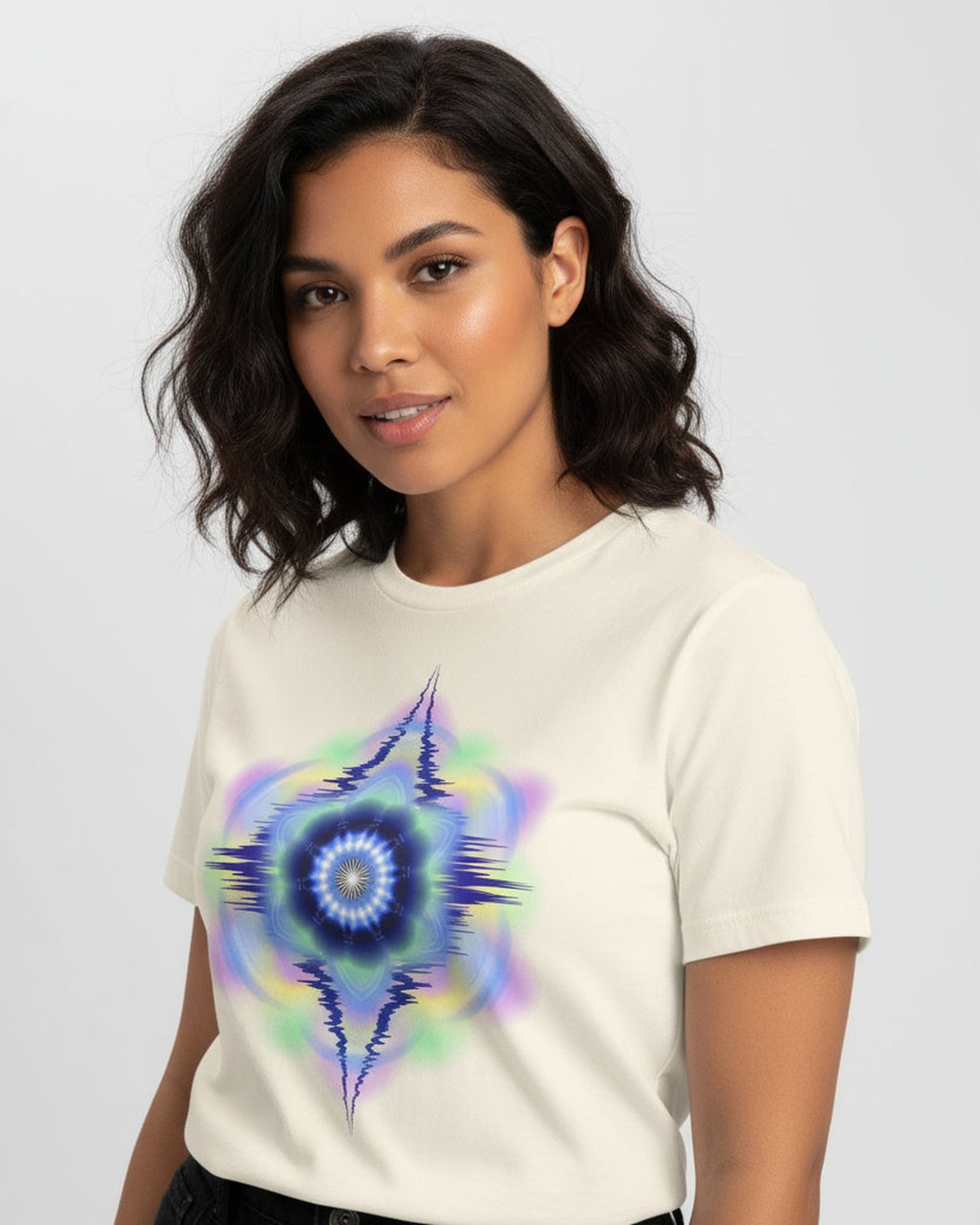 Woman wearing yellow t-shirt with a colorful abstract design on a light gray backgrounde.