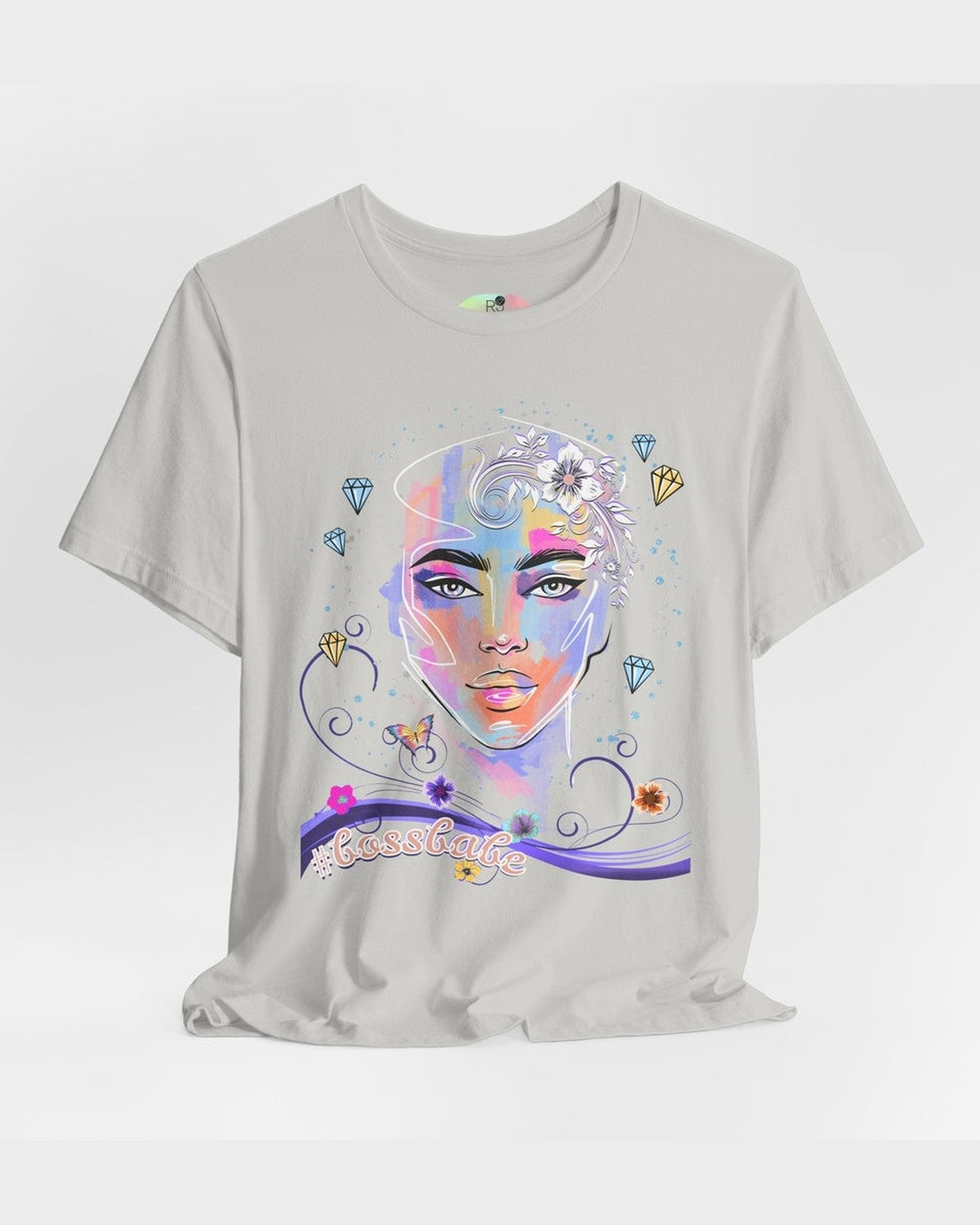 Grey t-shirt with a colorful graphic design of a female face, diamonds and flowers and a text #bossbabe on a white background