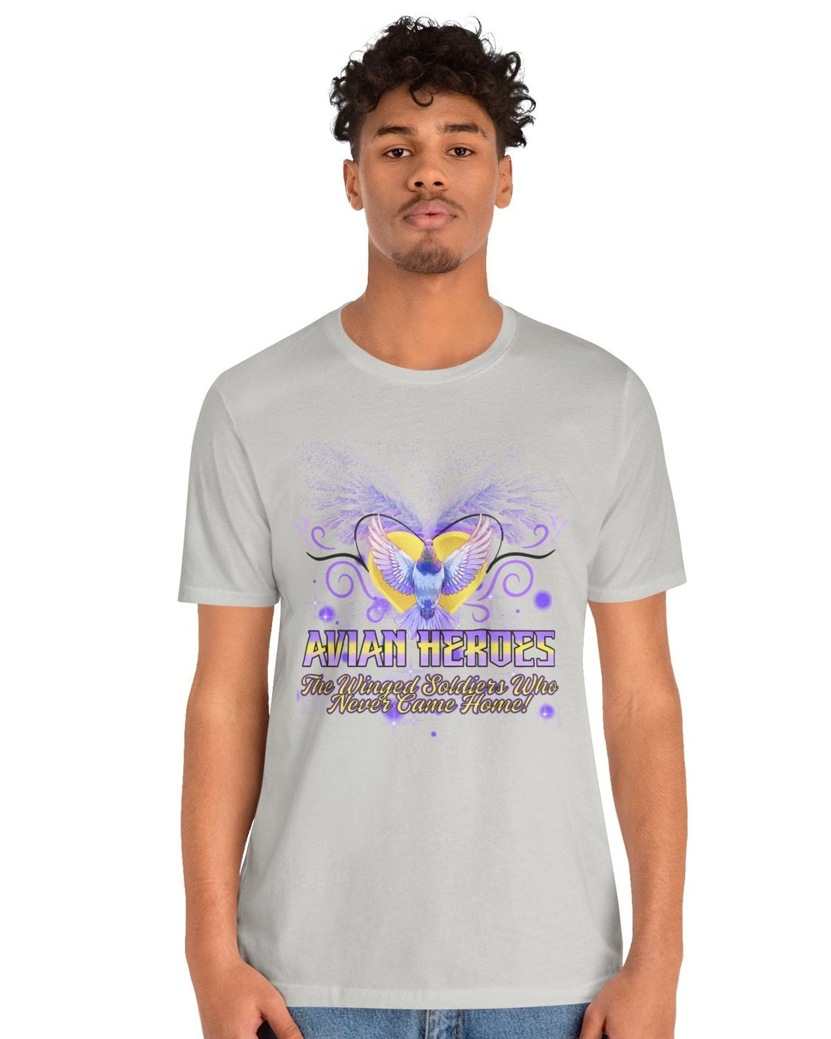 Person wearing a grey t-shirt with a purple & gold pigeon graphic and text Avian Heroes on a white background