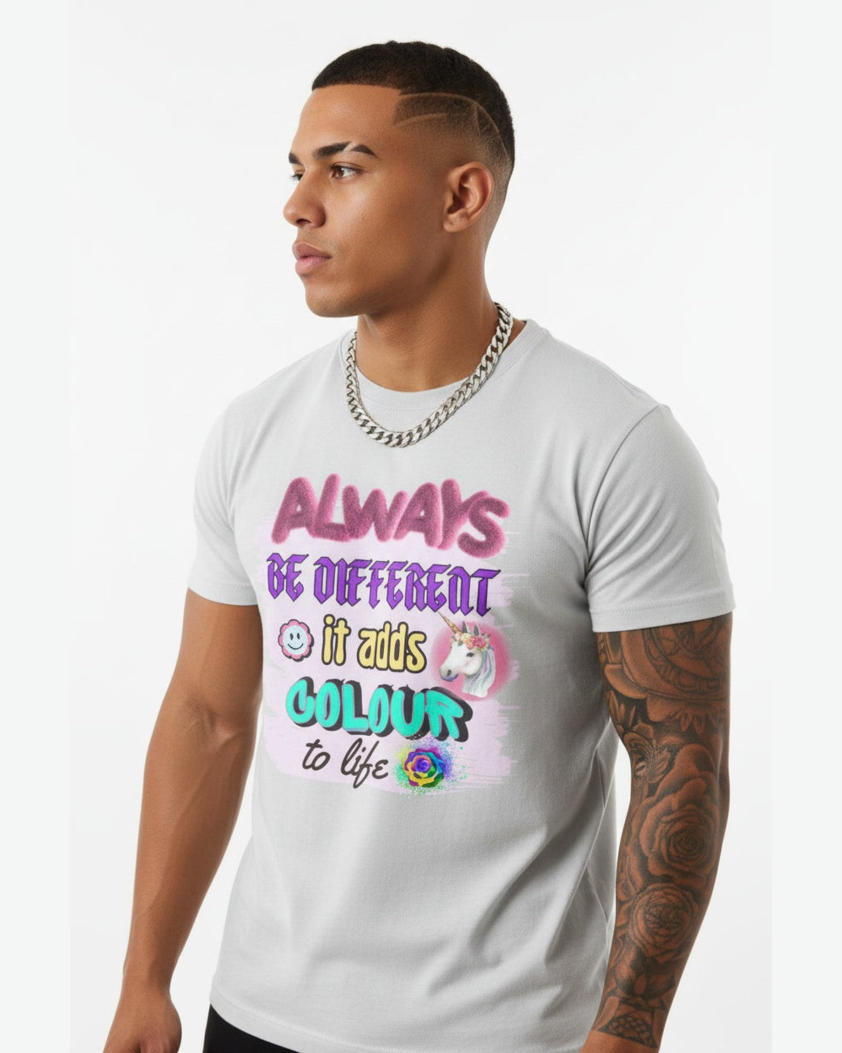 Man wearing a grey t-shirt with colorful motivational and graphics on a white background