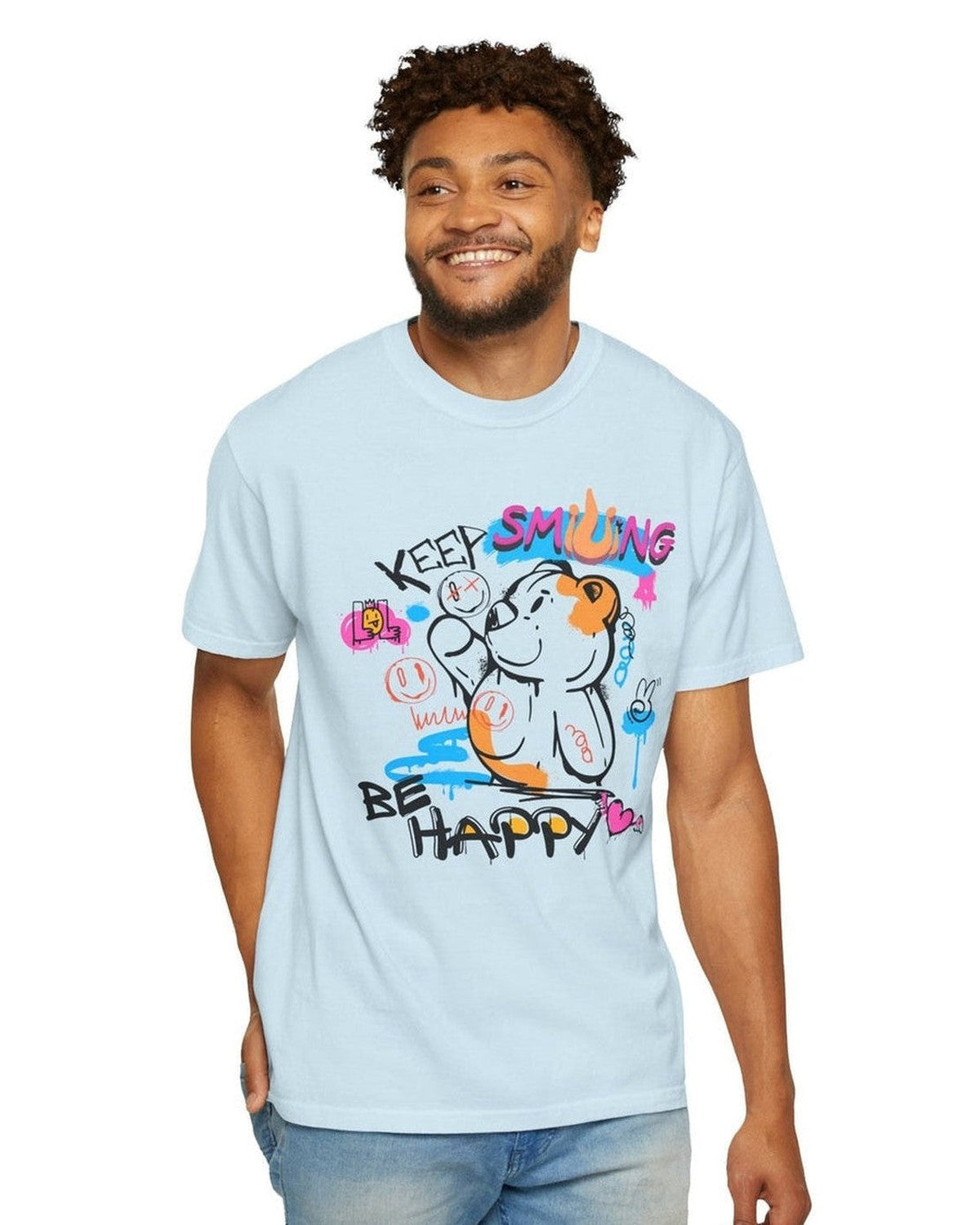 Man wearing a light blue t-shirt with colorful graphics and text Keep Smiling Be happy on a white background