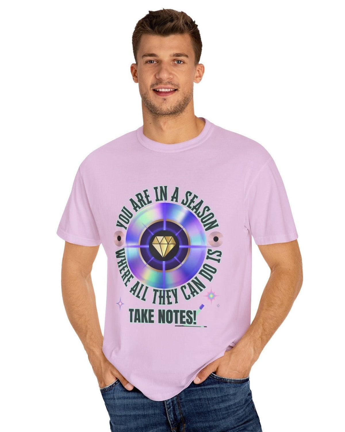 Man wearing a light purple t-shirt with a colorful graphic and text You are in a season where all they can do is take notes on a white background