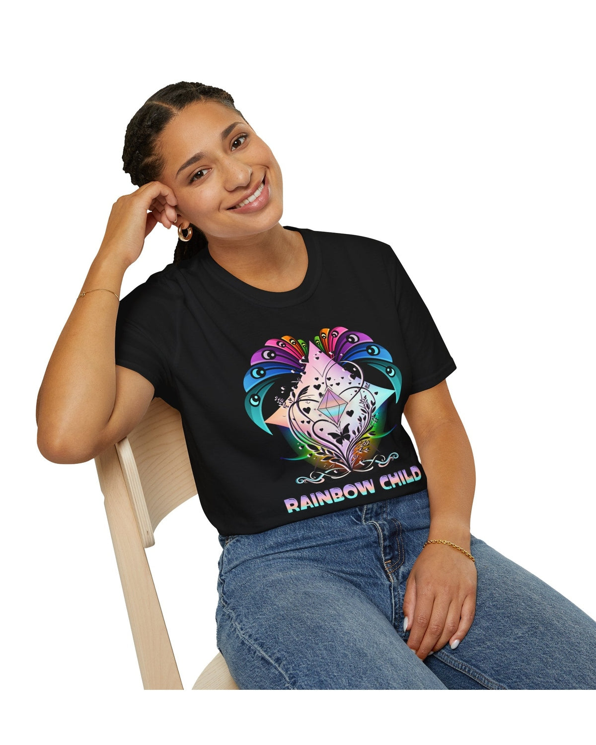 Person wearing a black t-shirt with a colorful design and 'Rainbow Child' text, sitting on a white background.