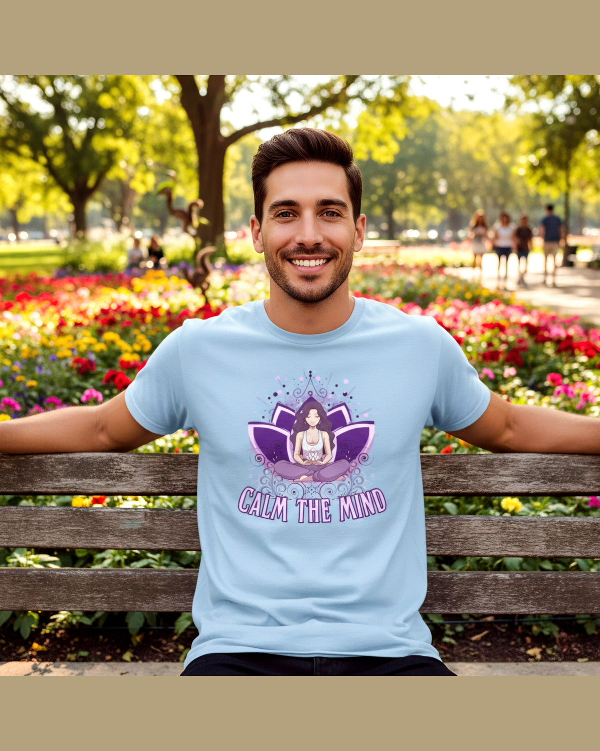 Man wearing a light blue tshirt with a meditation figure in a lotus and a text Calm the mind sitting on a bench in a park