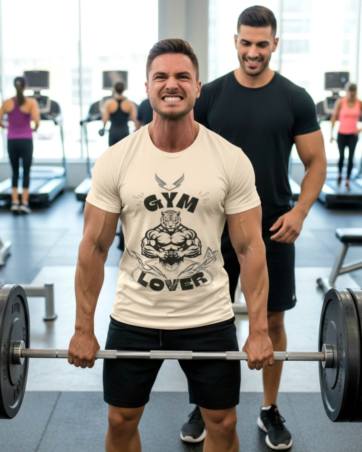 Man lifting weights in a gym wearing a cream t-shirt with black graphic design featuring a muscular tiger and 'Gym Lover' text with another man watching.
