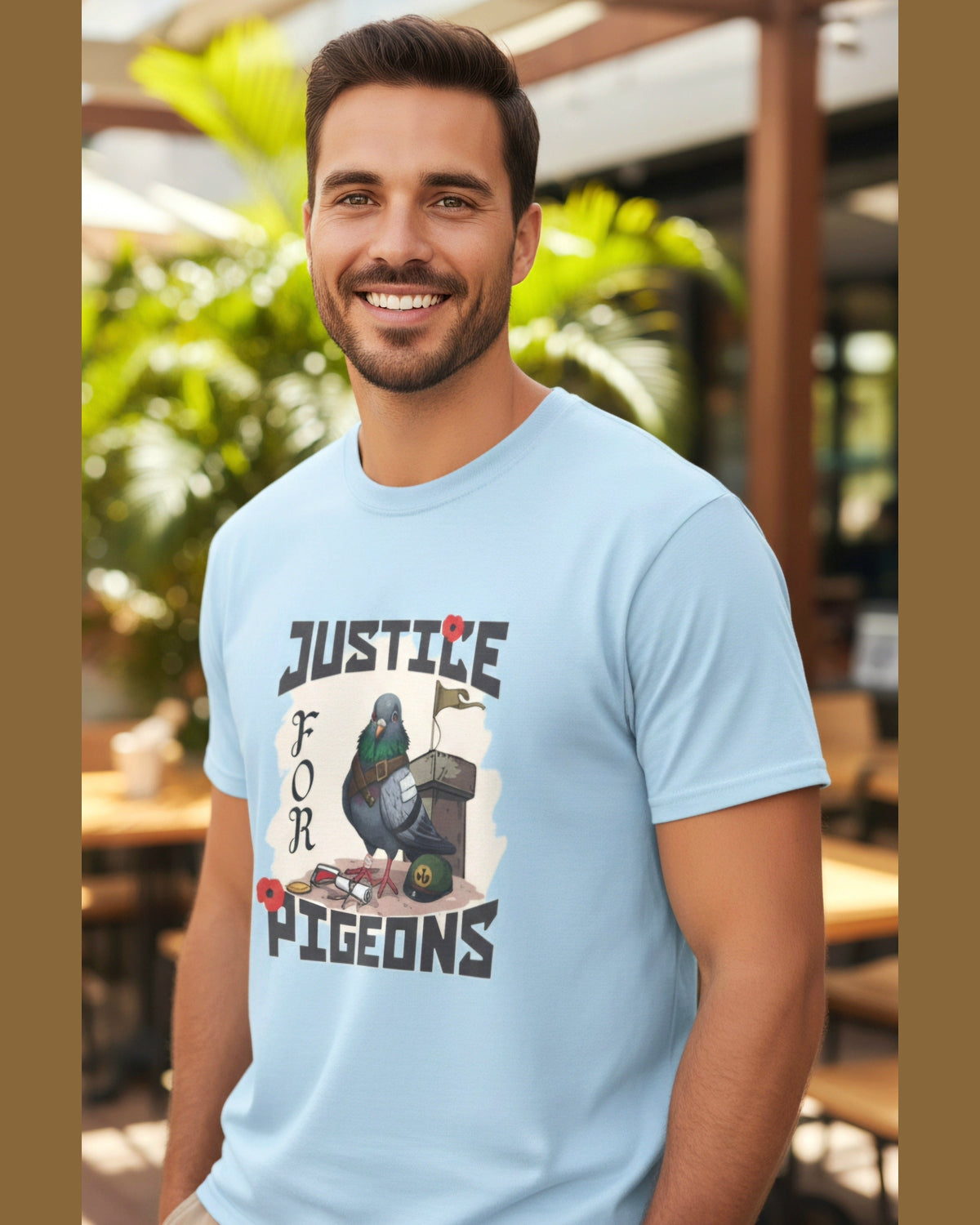 Man wearing a light blue t-shirt with a tribute pigeon graphic design and text Justice for Pigeons, standing outdoors.