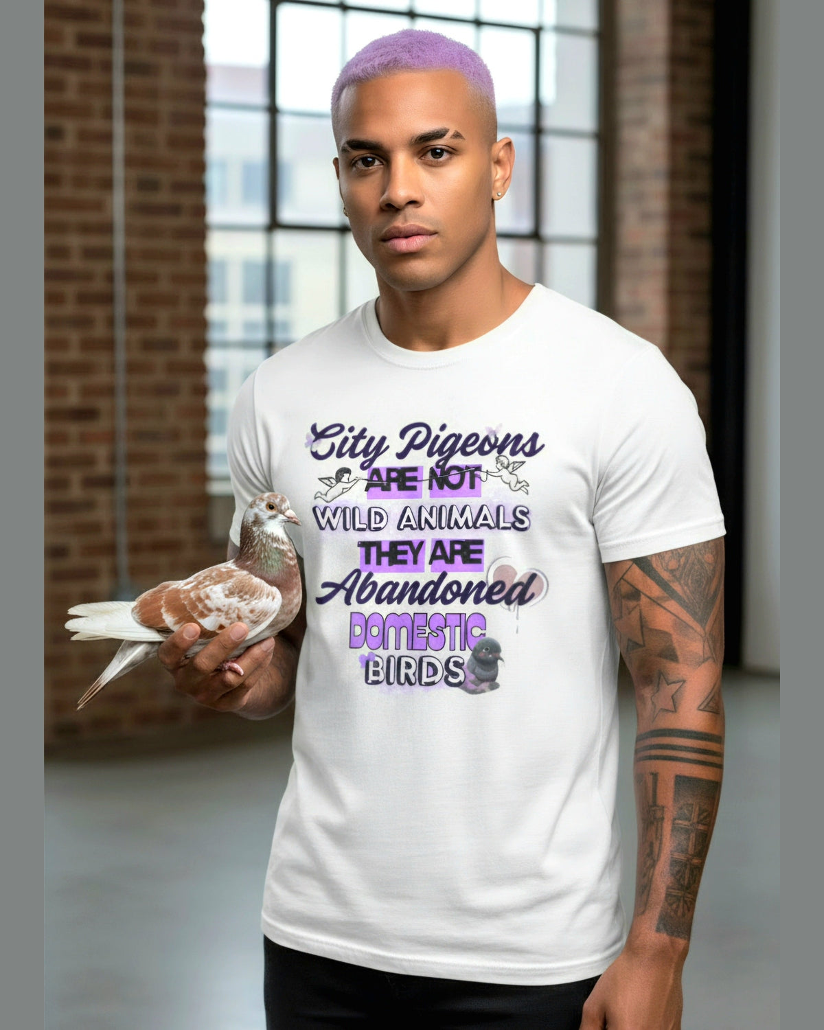 Man wearing a white t-shirt with pigeon awareness text holding a pigeon indoors.