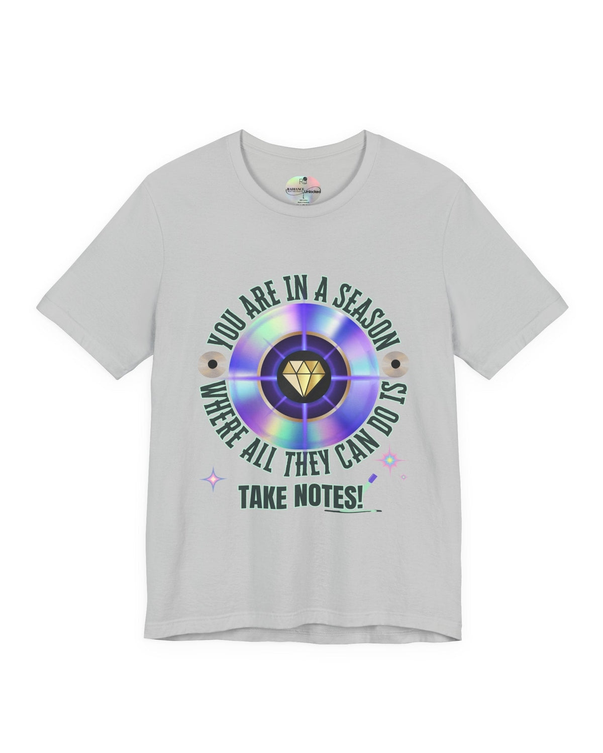 Gray t-shirt with a colorful graphic and text 'You are in a season where all they can do is take notes' on a white background