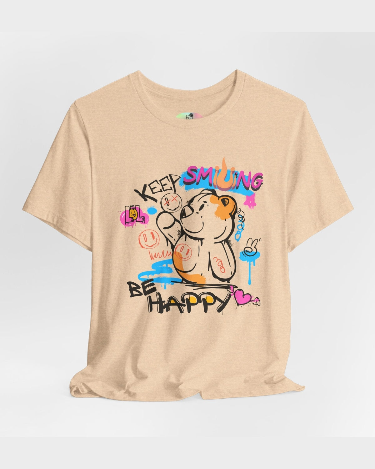 Beige t-shirt with colorful graphic design and text Keep smiling, Be Happy on a light grey background