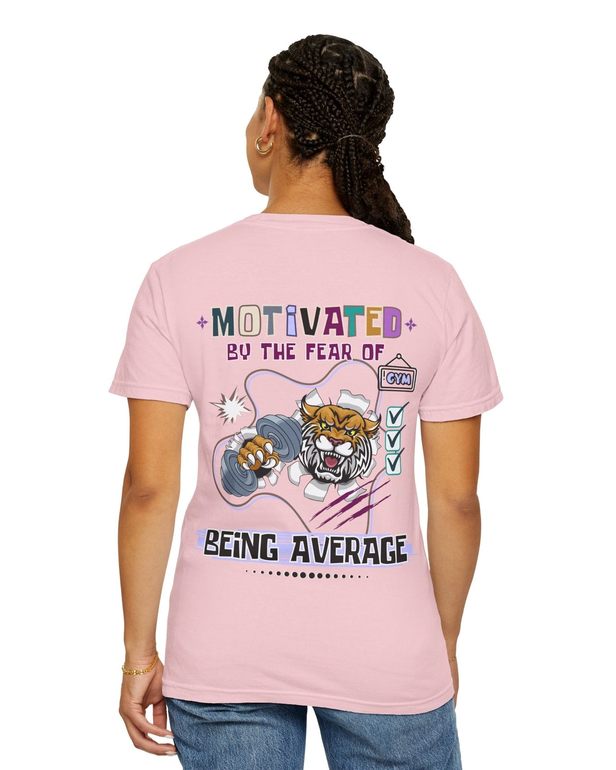 Person wearing a pink t-shirt with a motivational quote 'Motivated by the fear of being average' and tiger graphic design on the back.