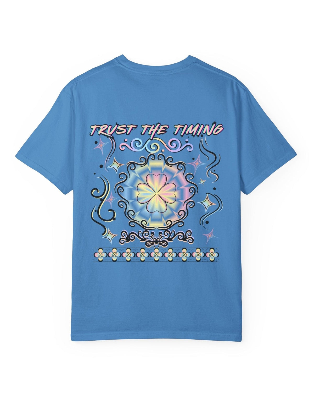A blue t-shirt with a colorful graphic four leaf clover design and a text trust the timing on a white background