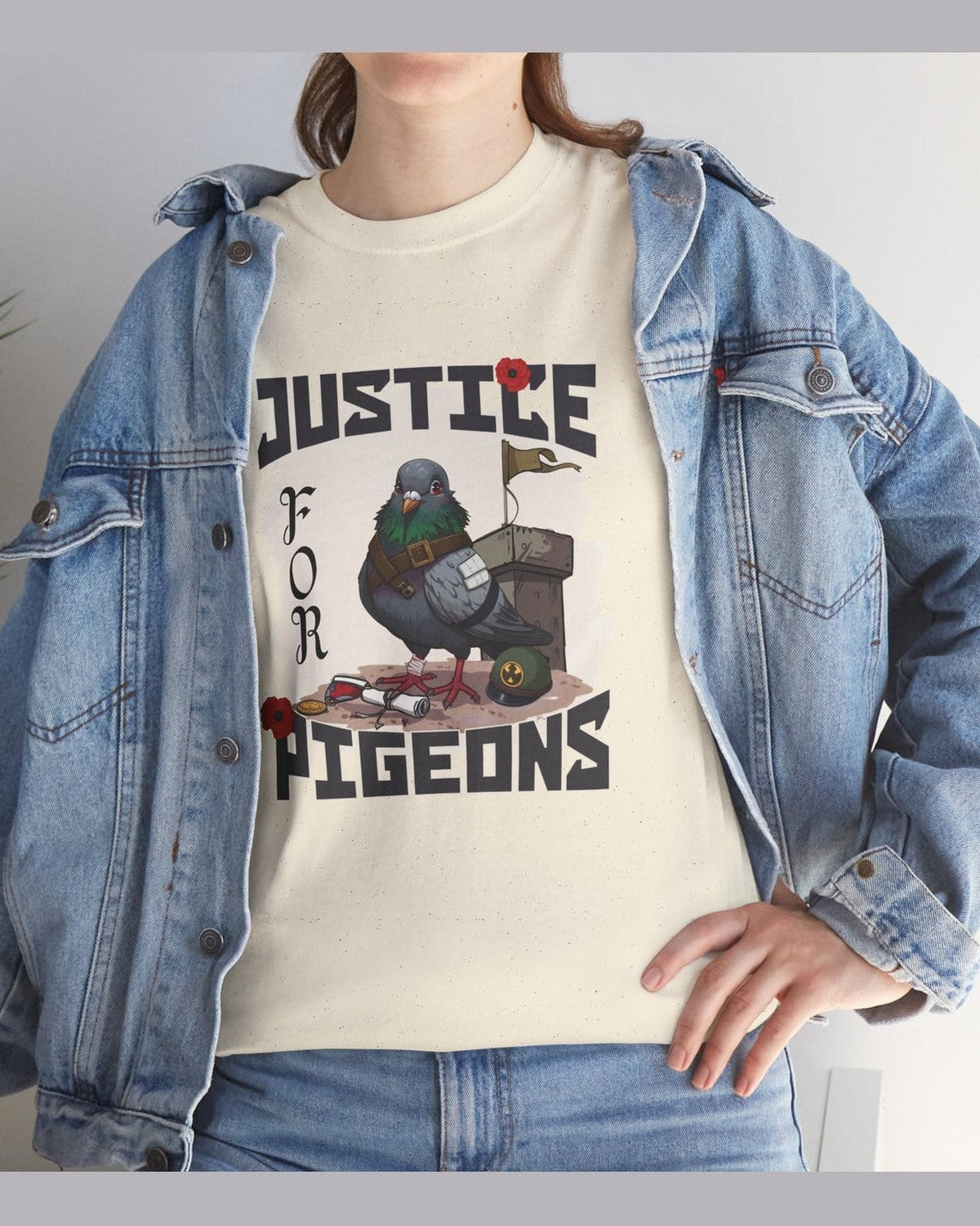 Person wearing a soft yellow t-shirt with 'Justice for Pigeons' graphic design, paired with a denim jacket.