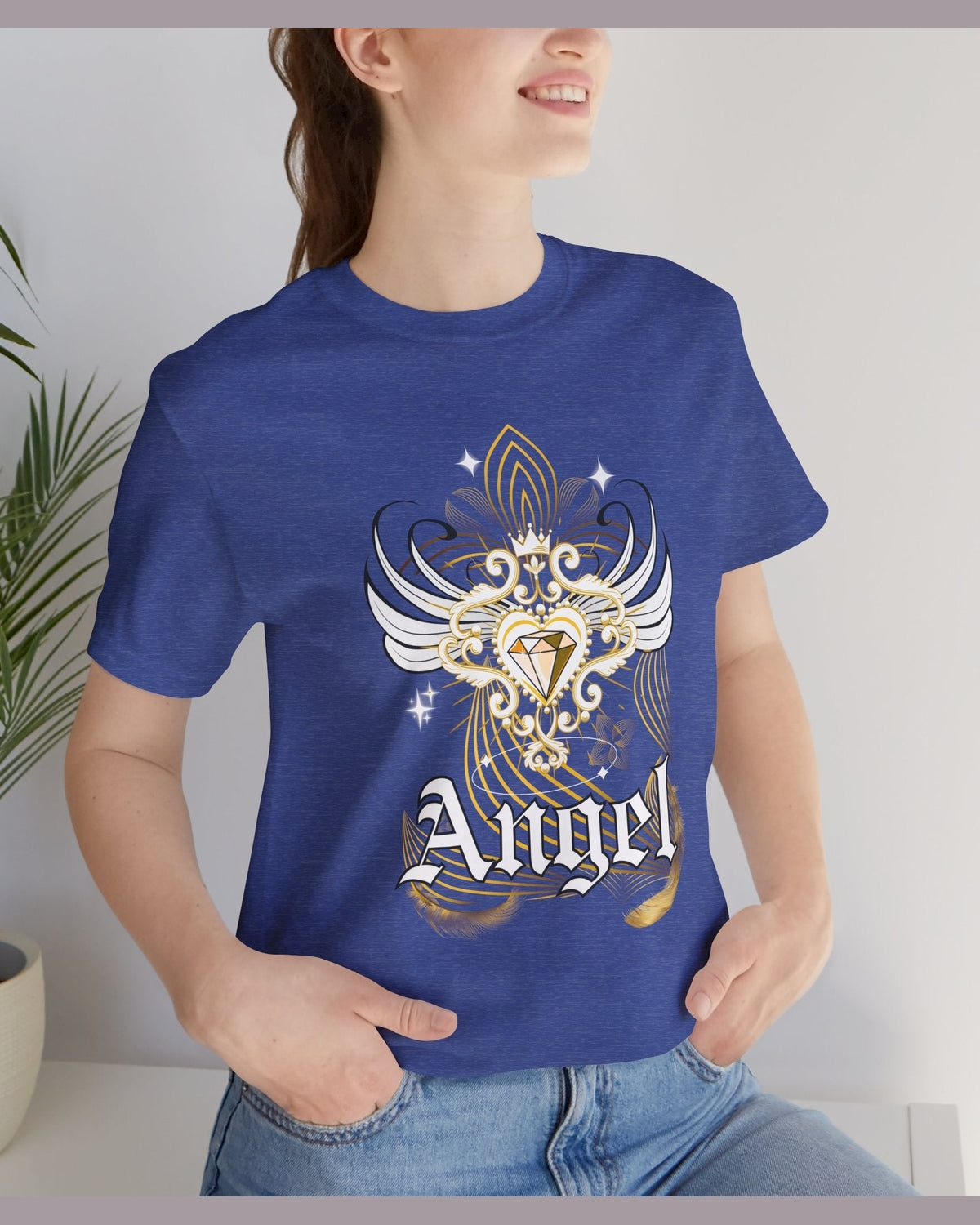 Person wearing a dull blue t-shirt with an angel design and 'Angel' text, standing indoors.
