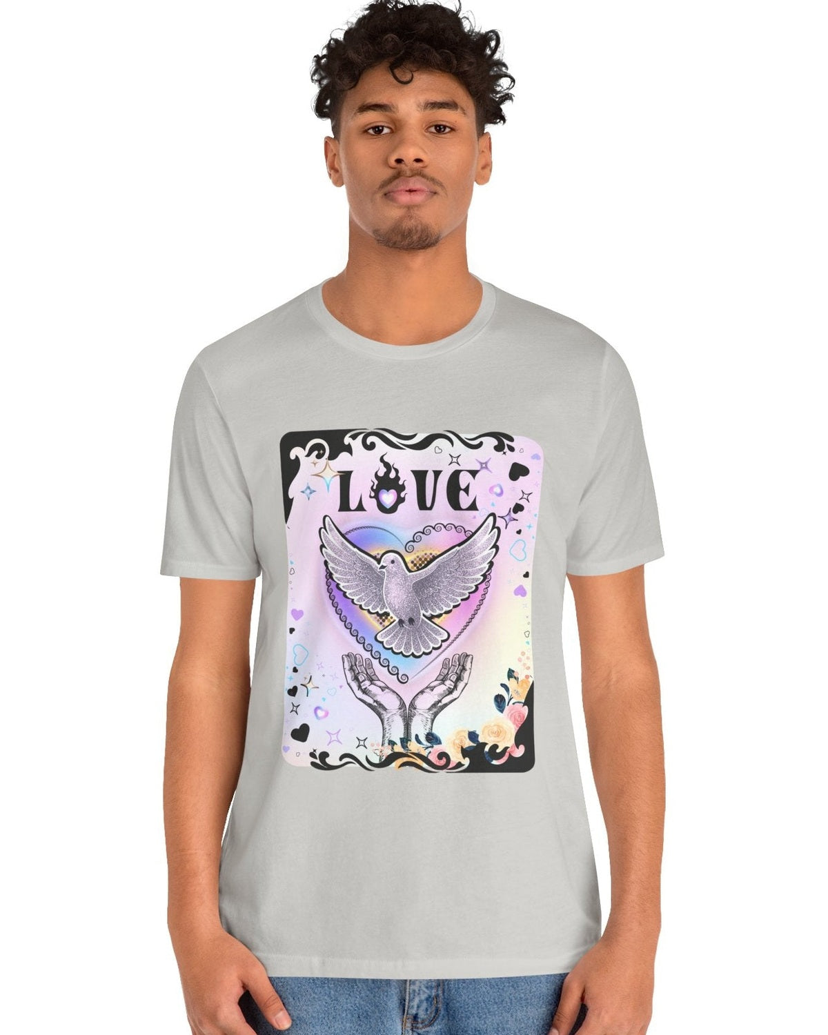 Man wearing a grey tshirt with vibrant pink and purple pastel colours, flowers and a pigeon in rainbow heart coming out of hands with the text Love on a white background 