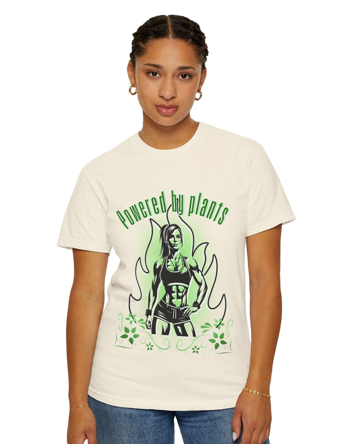 Person wearing a soft yellow vegan t-shirt with a graphic design and text Powered by Plants on a white background