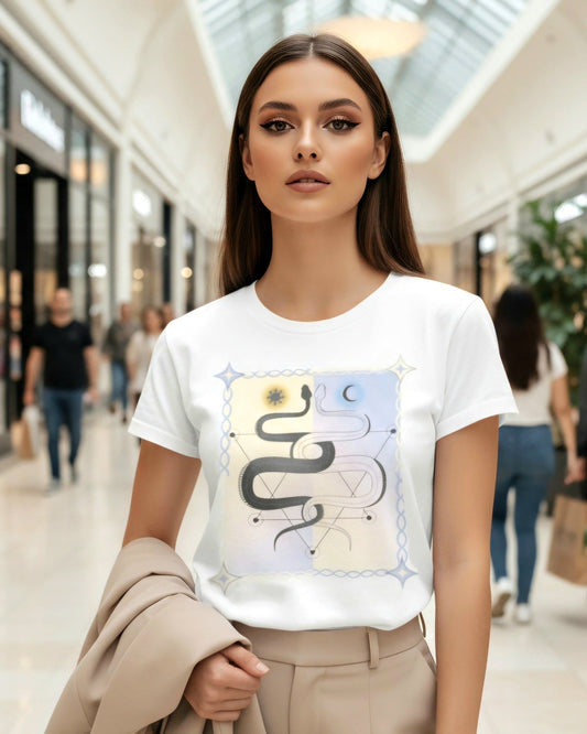 Woman wearing a white t-shirt with a yin yang inspired art and snakes in geometric shapes design in a mall setting