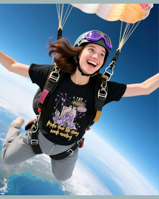 Person skydiving with a black harry potter isnpired t-shirt featuring a text 'The Magic is in you. Make your life story worth reading' and graphics.