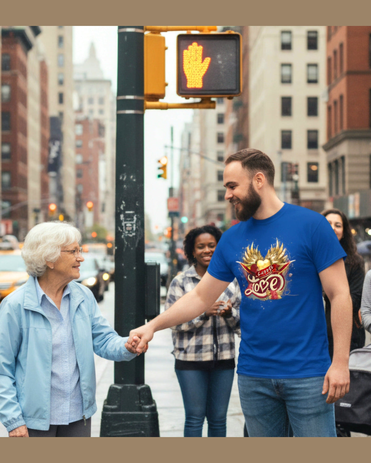 Man wearing a blue t-shirt with golden wings and heart and a text Choose Love standing on a traffic light helping an elderly 
lady cross.