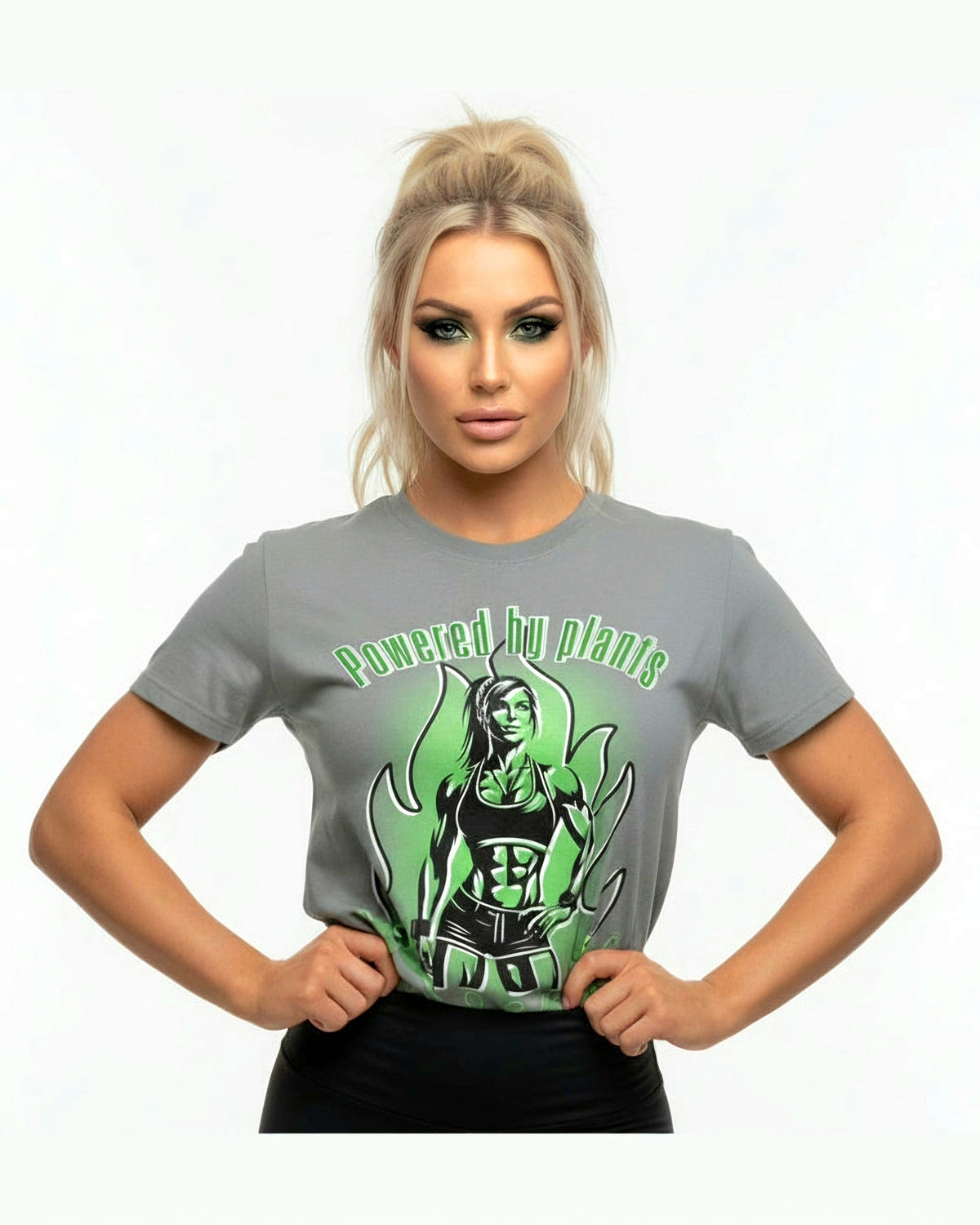 Grey t-shirt with green graphic design featuring a vegan fitness woman and 'Powered by plants' text on a white background.