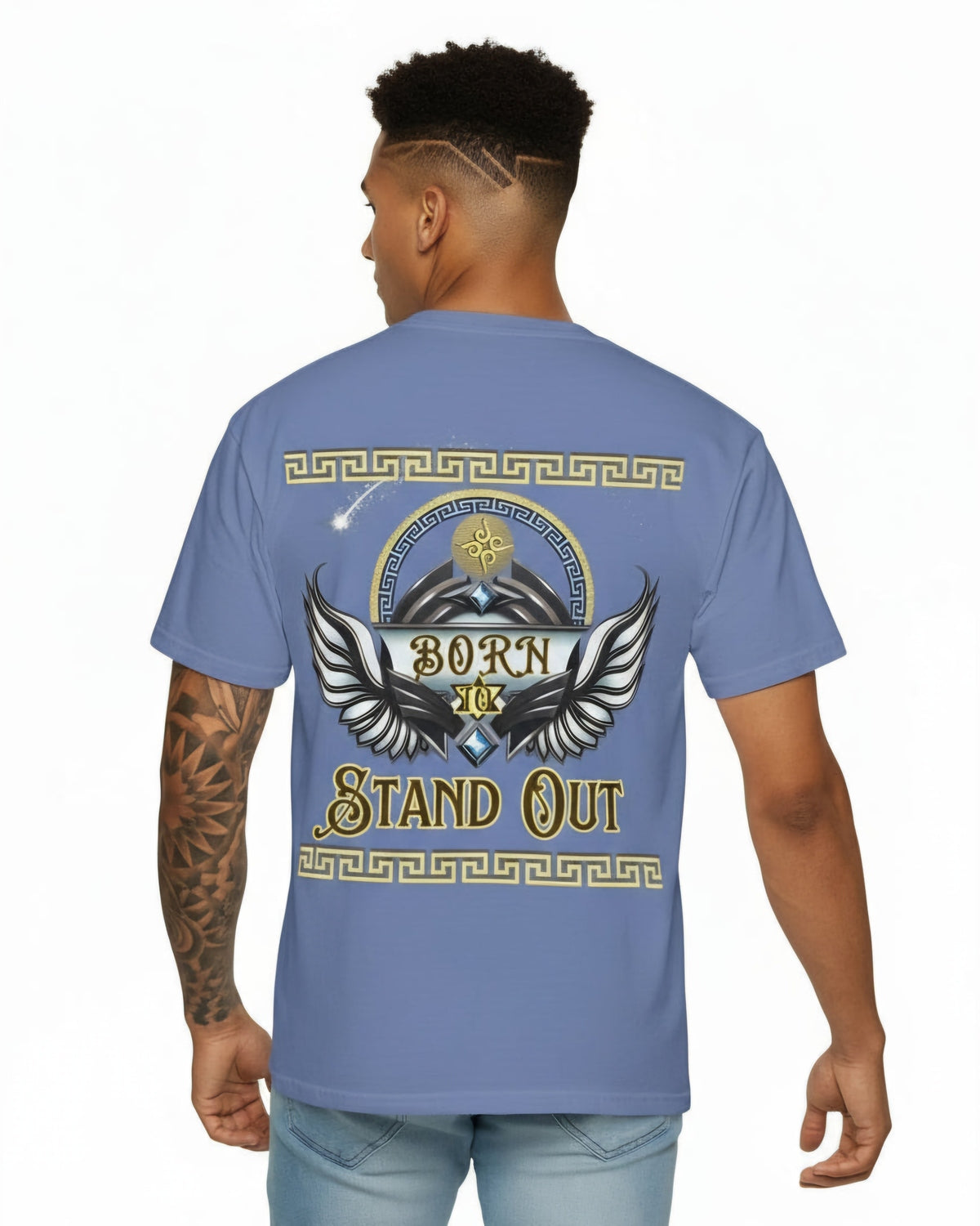 Man wearing a blue t-shirt with a winged design and text Born to Stand Out on the back, standing against a white background.