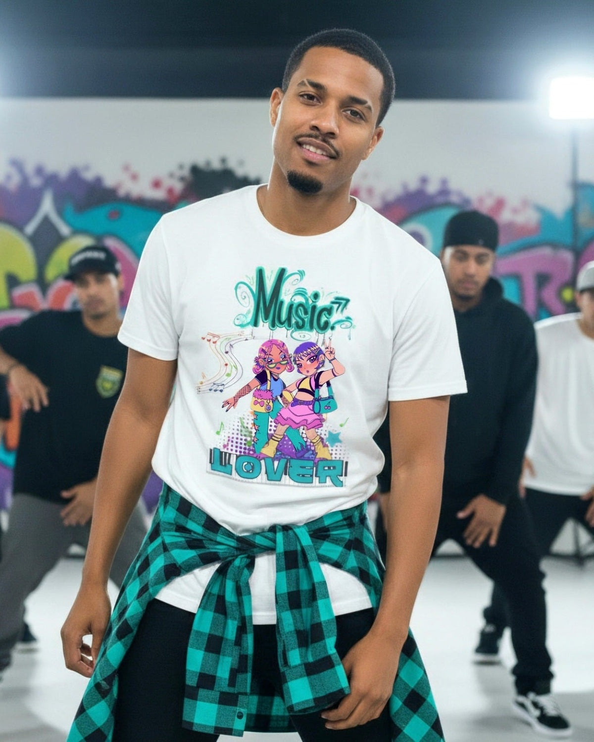 Man in a dance studio wearing a vibrant 'Music Lover' t-shirt with anime characters and others dancing in the background.