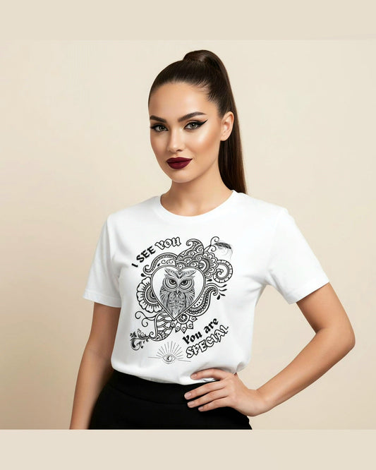 Woman wearing a white t-shirt with an owl design and text I see you, you are Special on a beige background