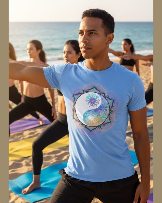 Man wearing Blue t-shirt with a colorful yin yang symbol doing yoga on the beach 